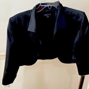 Cropped black satin jacket with pop collar and 3/4 sleeves.